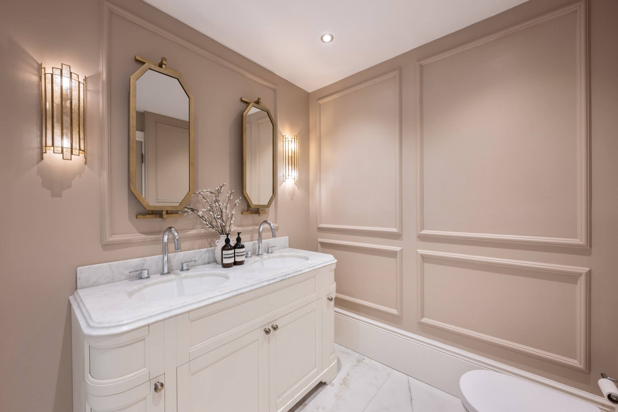 Clapham bathroom with panelled walls and brass mirrors