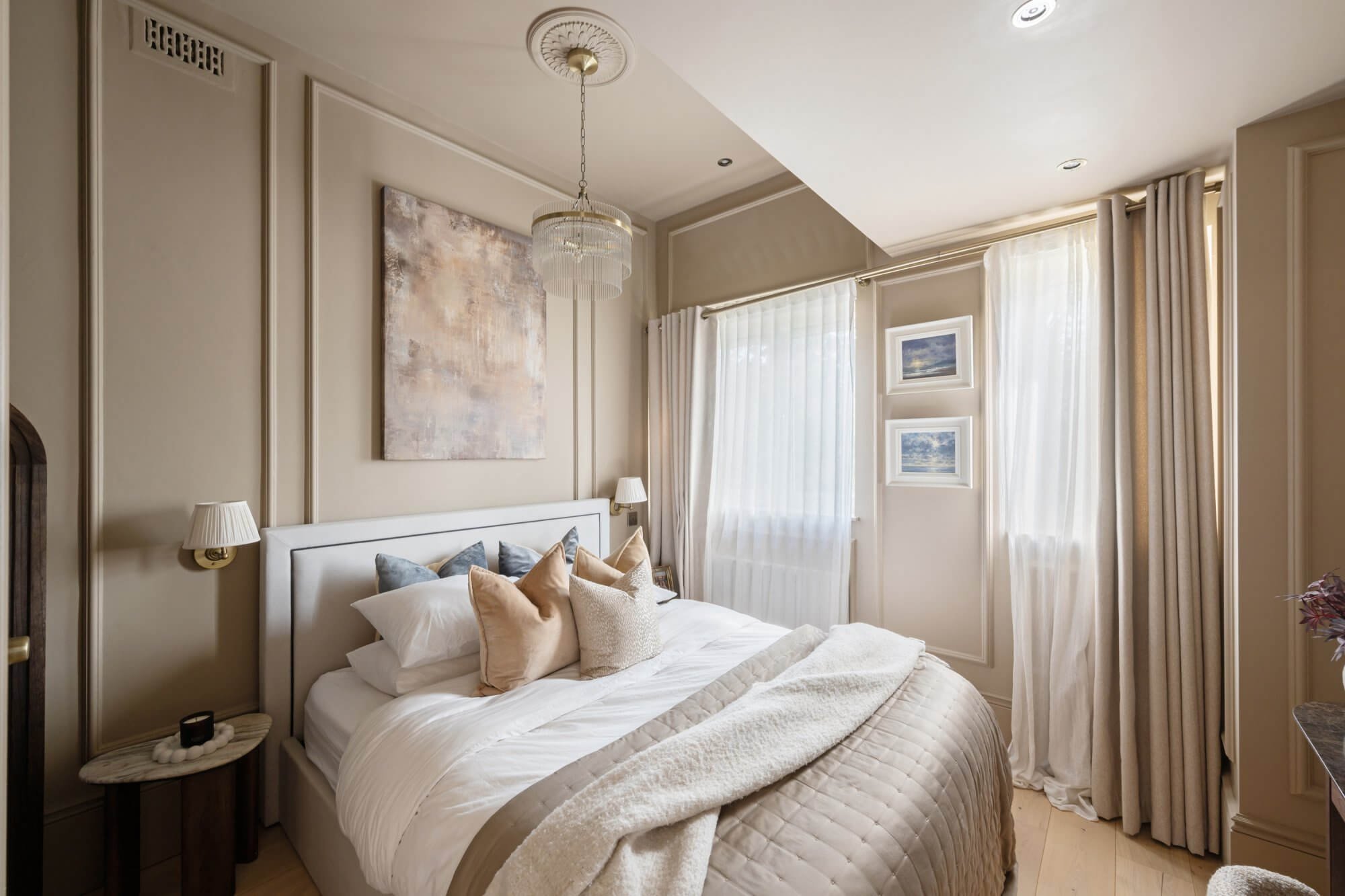 Clapham main bedroom with panelled walls and crystal chandelier