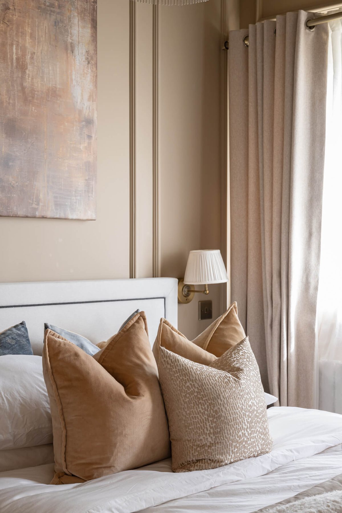 Layered cushions and curtains in the bedroom