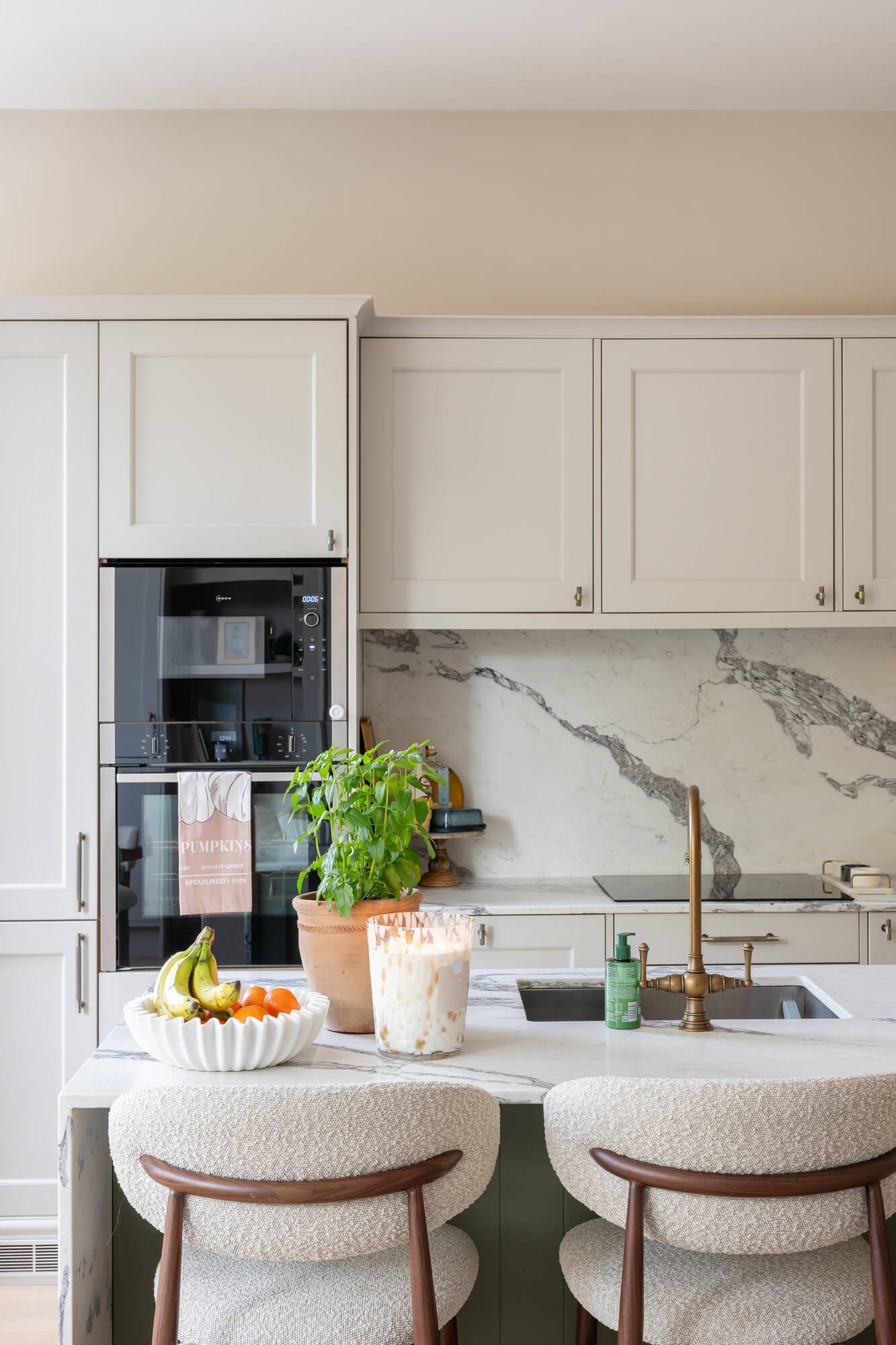 Marble waterfall island with sage joinery